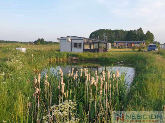 Działka 1200 m² z domkiem całorocznym– Kopcie
